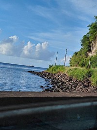 Stunning, landscape view of rock ridges which project out onto the Sea's edge, with the hilly vegetation overlooking this tranquil scenery.