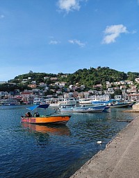 Fishing Vessels lay at rest on thde calm blue waters at the Harbor's site, on the Carenage, St. Geoge's